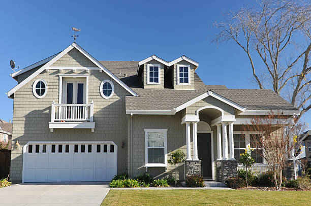 Exterior of a two-story home with a manicured lawn stock photo