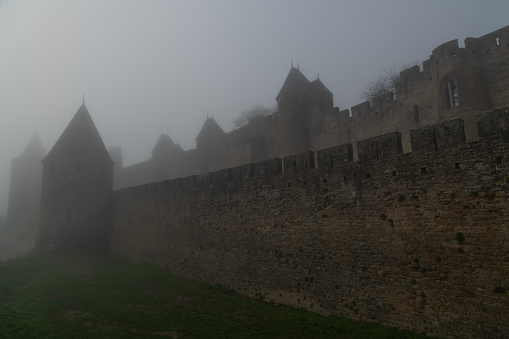 Ramparts, Walls and Towers of Carcassonne on foggy New Years Day, France 01.01.2022