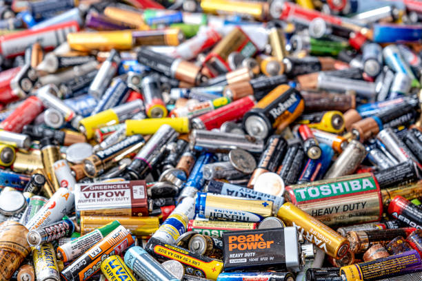 Used batteries from different manufacturers stock photo