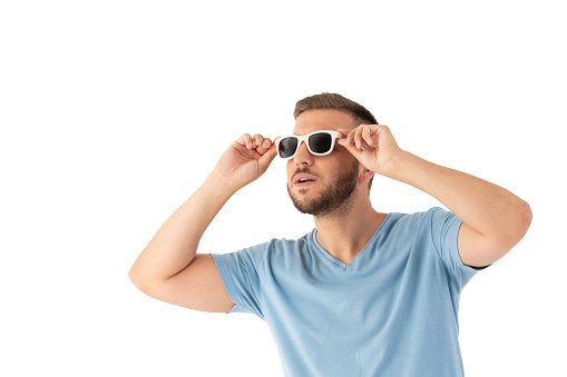 Surprised man looking up with a sunglasses on a perfect white background