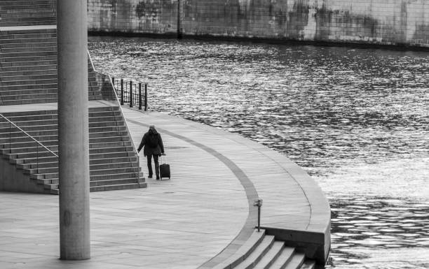 istock Rear View Of Man Standing On Railing By Lake 1363402257