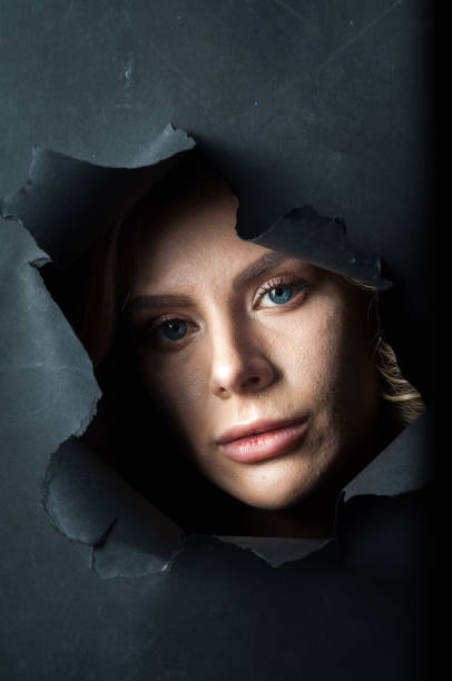 istock The girl's face appears on a black background. 1363403829