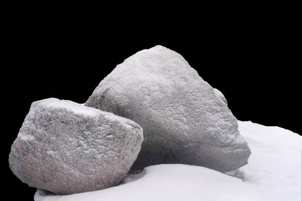 istock natural stone in snow isolated on black background 1363406068