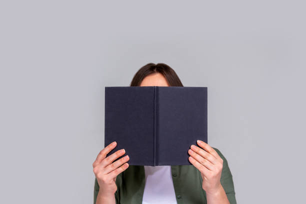 istock Caucasian unrecognizable woman hiding behind day planner 1363407995