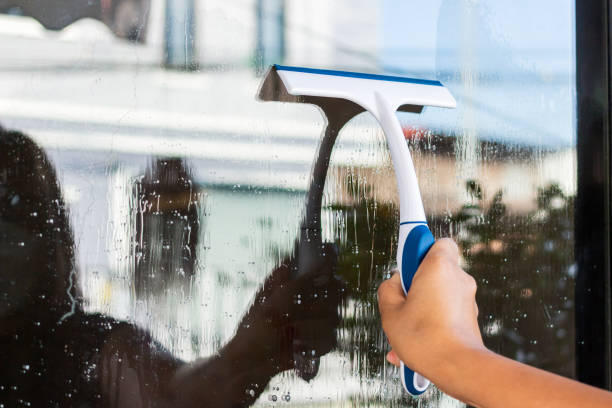 istock woman cleaning soap suds on glass window 1363408730