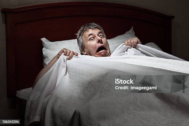 Man Startled Awake By Intruder Stock Photo - Download Image Now - Fear, Horror, Bed - Furniture
