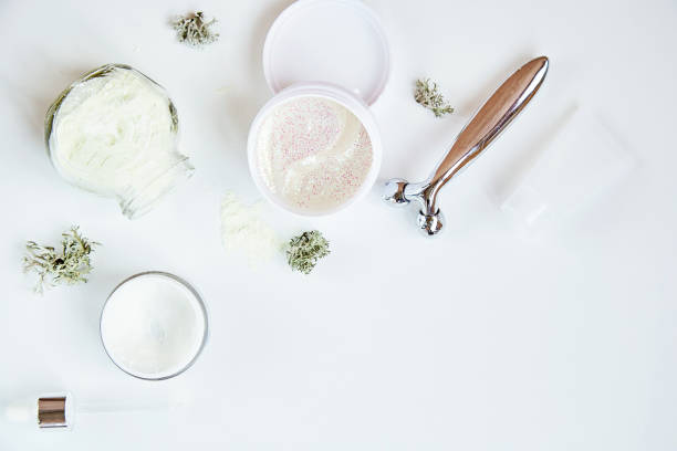 istock Alginate mask and transparent patches. Wellness face care cosmetics set on white gradient background. Cream and massager. Natural moss. Hyaluronic and moisturizing cosmetic. Dermatology products 1363413207