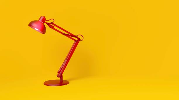 istock Red desk lamp on yellow background 1363414923