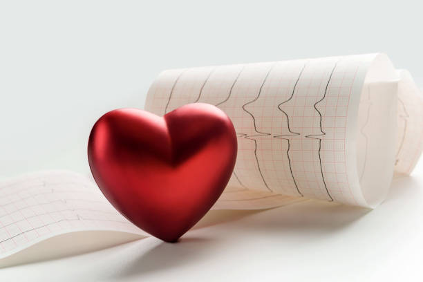 Cardiogram sheet and heart symbol close up. Cardiogram sheet and heart symbol close up. cardiovscular risk stock pictures, royalty-free photos & images