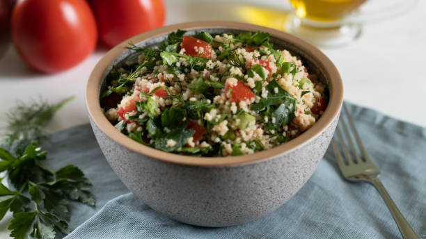 istock Traditional Arabic salad Tabbouleh on a white background with gray textiles 1363416213