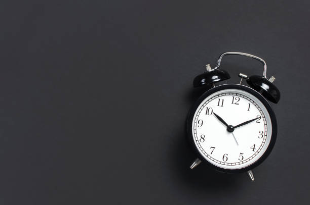 istock Black retro alarm clock on gray dark background top view Flat lay copy space. Minimalistic background, concept of time, deadline, time to work, morning 1363416996
