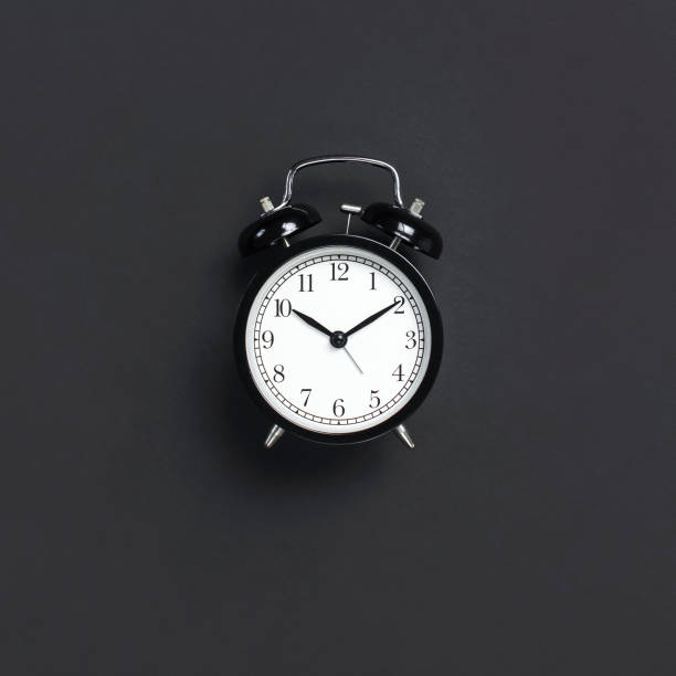 istock Black retro alarm clock on gray dark background top view Flat lay copy space. Minimalistic background, concept of time, deadline, time to work, morning 1363416997