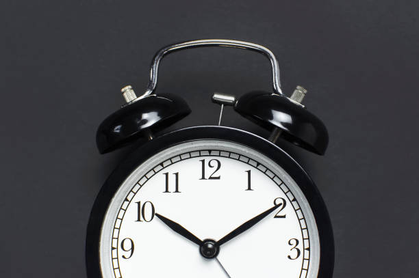 istock Black retro alarm clock on gray dark background top view Flat lay copy space. Minimalistic background, concept of time, deadline, time to work, morning 1363417000