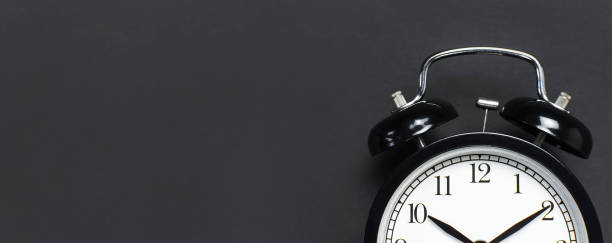 istock Black retro alarm clock on gray dark background top view Flat lay copy space. Minimalistic background, concept of time, deadline, time to work, morning 1363417003