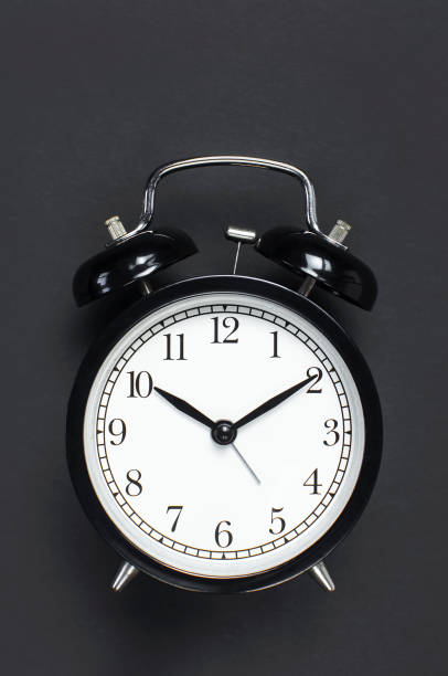 istock Black retro alarm clock on gray dark background top view Flat lay copy space. Minimalistic background, concept of time, deadline, time to work, morning 1363417005
