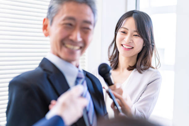 istock Female announcer doing an interview 1363419205