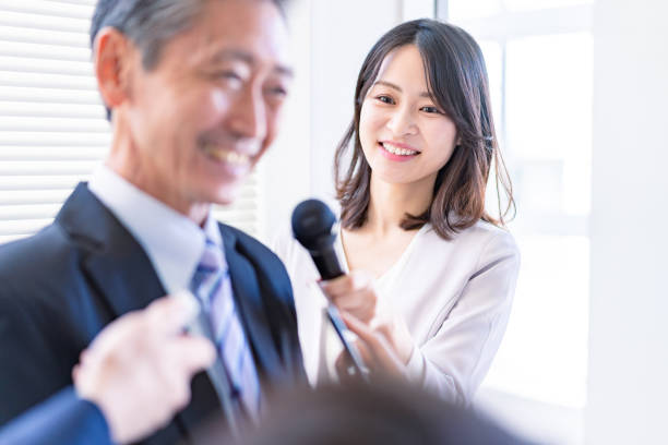 istock Female announcer doing an interview 1363419209