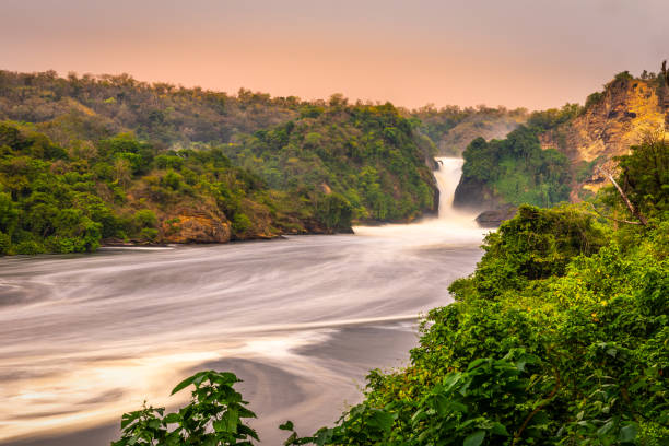 Long exposure of the Murchison waterfall on the Victoria Nile at sunset, Uganda. Long exposure of the Murchison waterfall on the Victoria Nile at sunset, Uganda.  Horizontal. nile river stock pictures, royalty-free photos & images