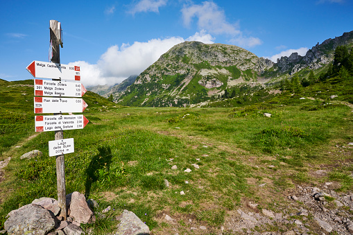 Trail sign at Buse Lake (Lago delle Buse). Lagorai Mountain Range.  Trentino-Alto Adige. Italy.