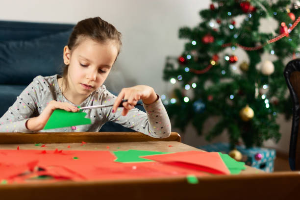 istock Child making Christmas decoration at home 1363424900