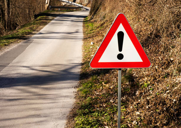 istock Sign for being cautious on road up front 1363432249