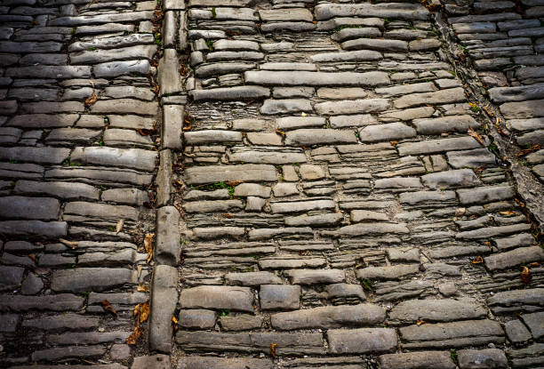 istock Old road pavement with stones 1363432278