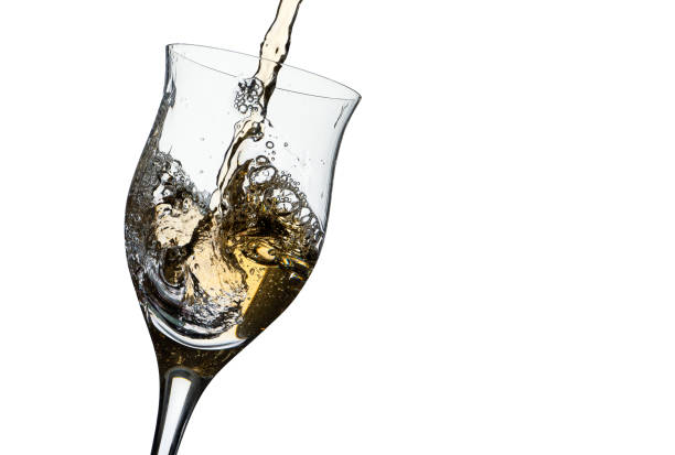 istock Serving a slightly tilted glass with white wine. White background. Copy space. Concept of movement, elegance, taste. 1363434414