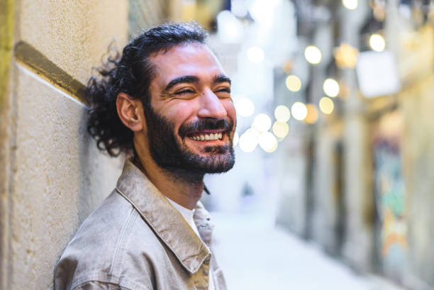 istock Cheerful Hispanic male leaning on wall 1363435865