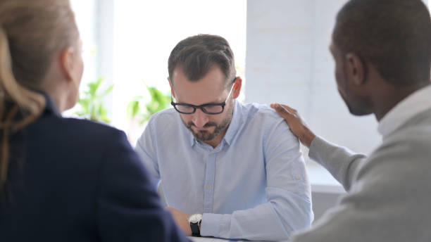 istock Business People Reassuring Upset Businessman 1363437330