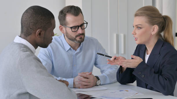 istock Businesswoman Explaining Documents to Male Colleagues 1363440012