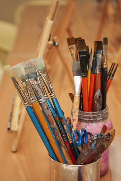 istock art brushes stained with paint in a jar 1363441306