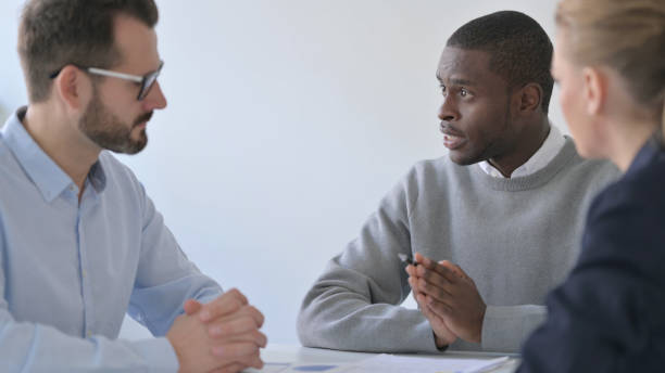 istock Professional African Businessman Dicsussing Project with Colleagues 1363441347