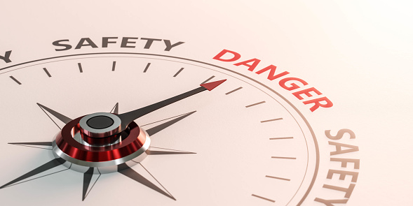 compass pointing at written word danger besides the word safety 3d render illustration red lighting danger business failure challenge orientation concept