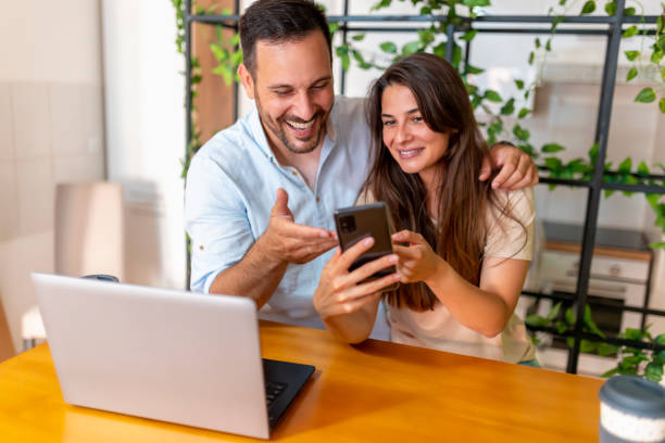 Couple surfing the Internet using smartphone stock photo
