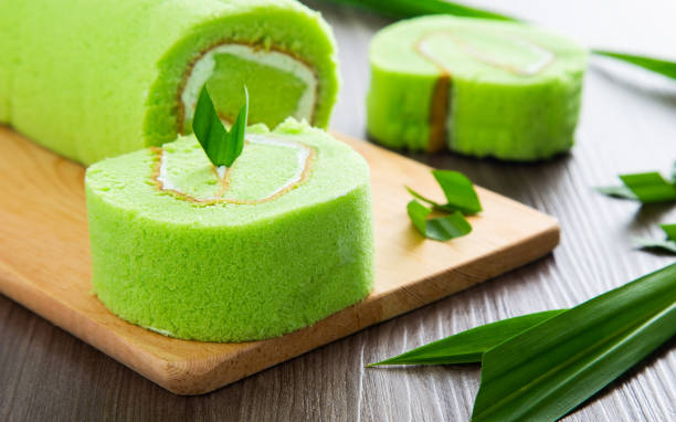 istock Pandan swiss roll cake on wooden table. 1363443435