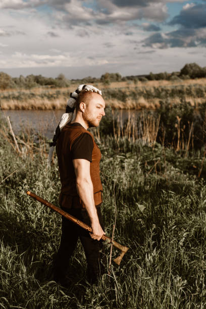 istock A young man with an interesting depicts a Viking with an ax in an unreliable stylized modern costume 1363444523