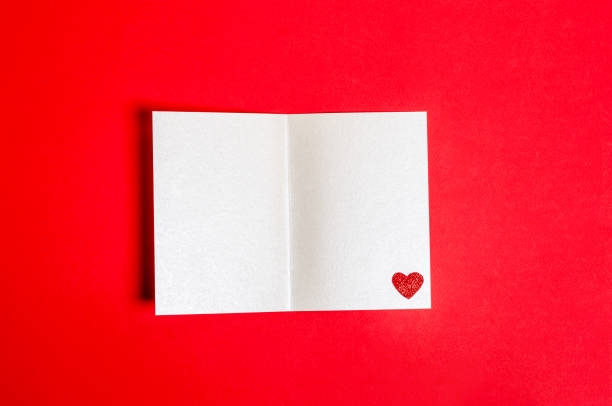 istock Blank postcard with a shiny heart on a red background for Valentine's Day. 1363444535