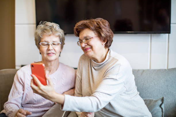 istock Two active senior females making selfie at home 1363447186