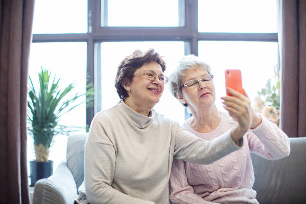 istock Two active senior females making selfie at home 1363447208