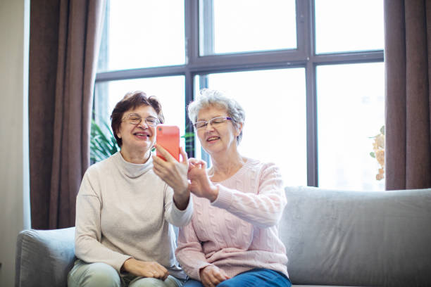 istock Two active senior females making selfie at home 1363447238