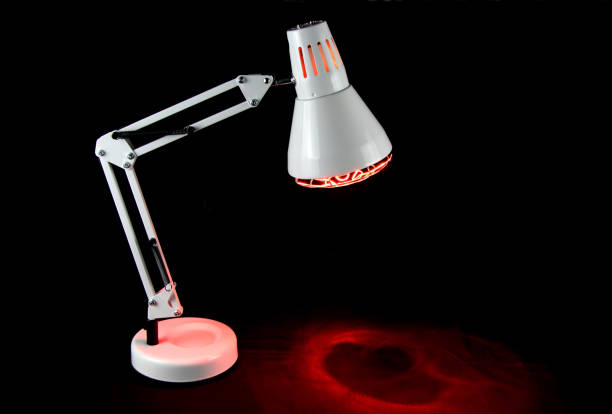 istock Illuminated Infra Red Health Lamp on a Black Surface 1363447385