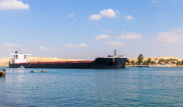 istock Bulk carrier ship with black hull passes the Suez Canal 1363448603