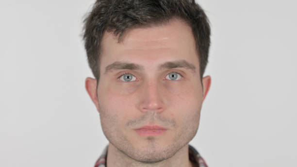 istock Close up of Serious Young Man Looking at Camera 1363450654