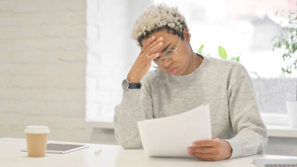 istock African Woman Upset while Reading Documents in Office 1363452225