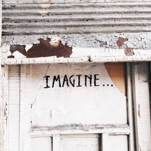istock 'Imagine' written on an old door 1363452271