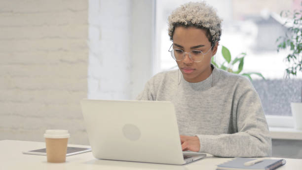 istock African Woman Working on Laptop in Office 1363452304