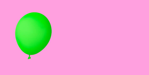 istock Green balloon insulated on pink background 1363453255