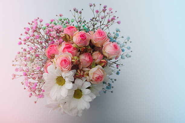 istock White roses and chrysanthemums on a white background. Bride's bouquet. background. Soft pastel colors. Background for postcards, invitations, and greetings. 1363453321