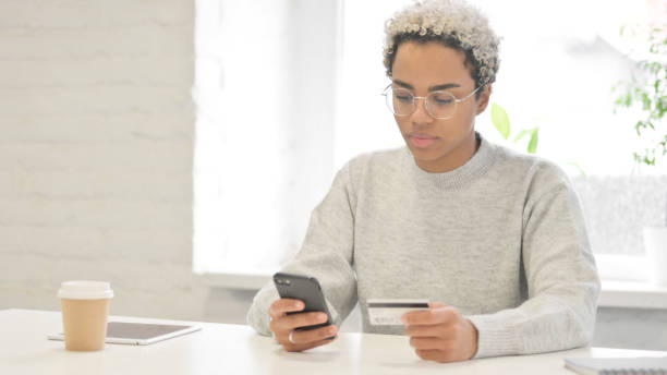 istock African Woman making Successful Online Payment on Smartphone 1363453896