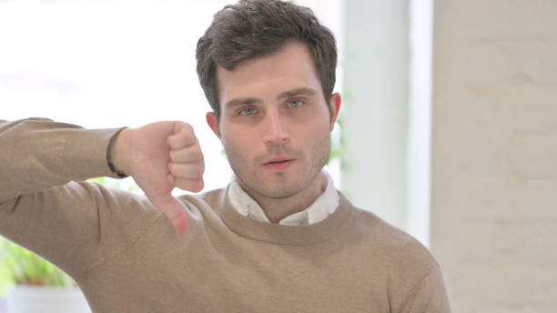 istock Portrait of Man showing Thumbs Down Gesture 1363456190
